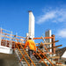 Total Aluminium adjustable aluminium stair in use on a building site, worker climbing to the slab AS-09STEPW